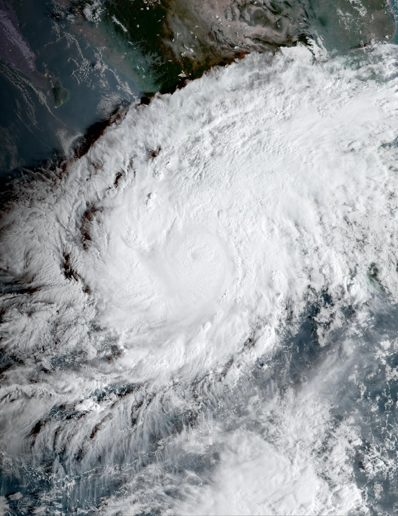 Satellite view of Hurricane Simon, a tight eye inside a vast cloud swirl just off Mexico's Pacific coast