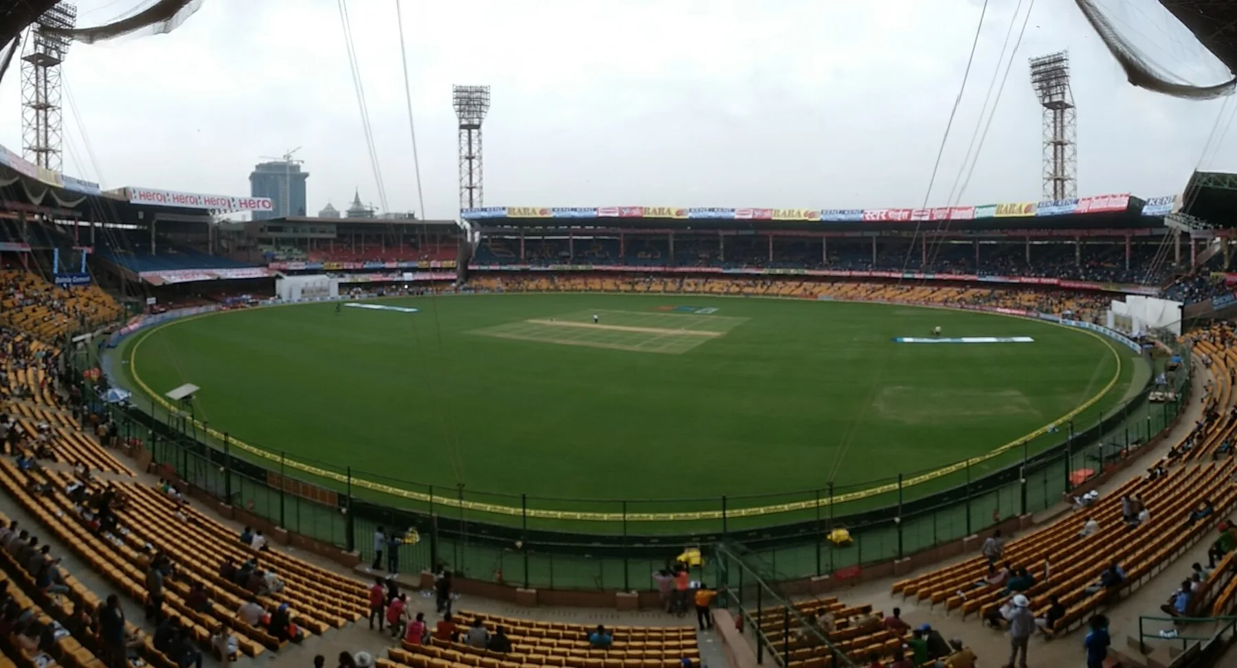 Wide view of the M Chinnaswamy Stadium in Bengaluru with its stands and floodlights around the field