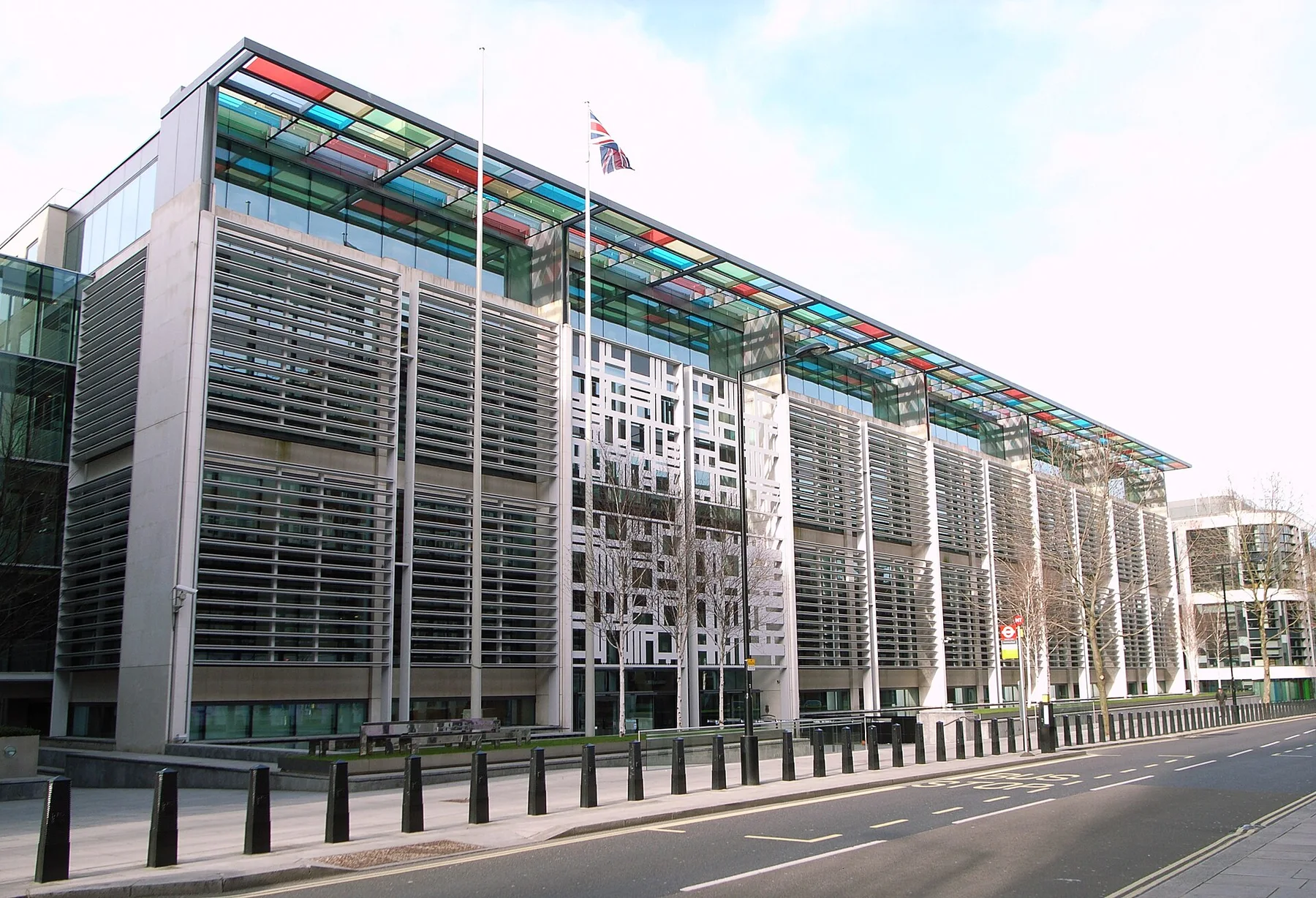 Home Office headquarters at 2 Marsham Street, a long building with coloured glass canopy and Union flag