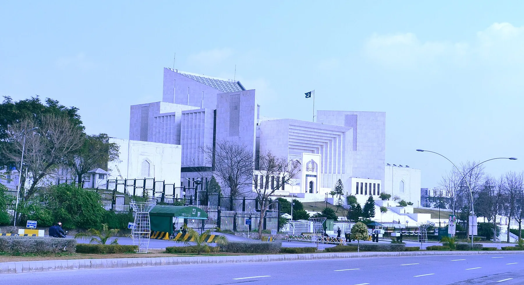 White marble Supreme Court of Pakistan building in Islamabad with the national flag on its roof