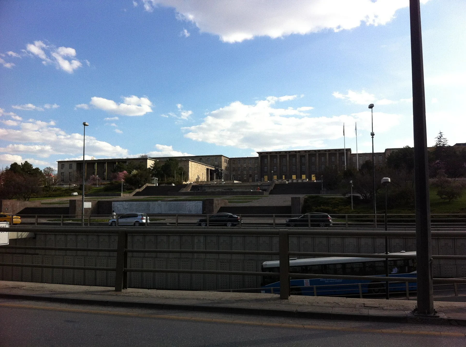 Grand National Assembly of Turkey buildings in Ankara seen across a road, a blue bus in front