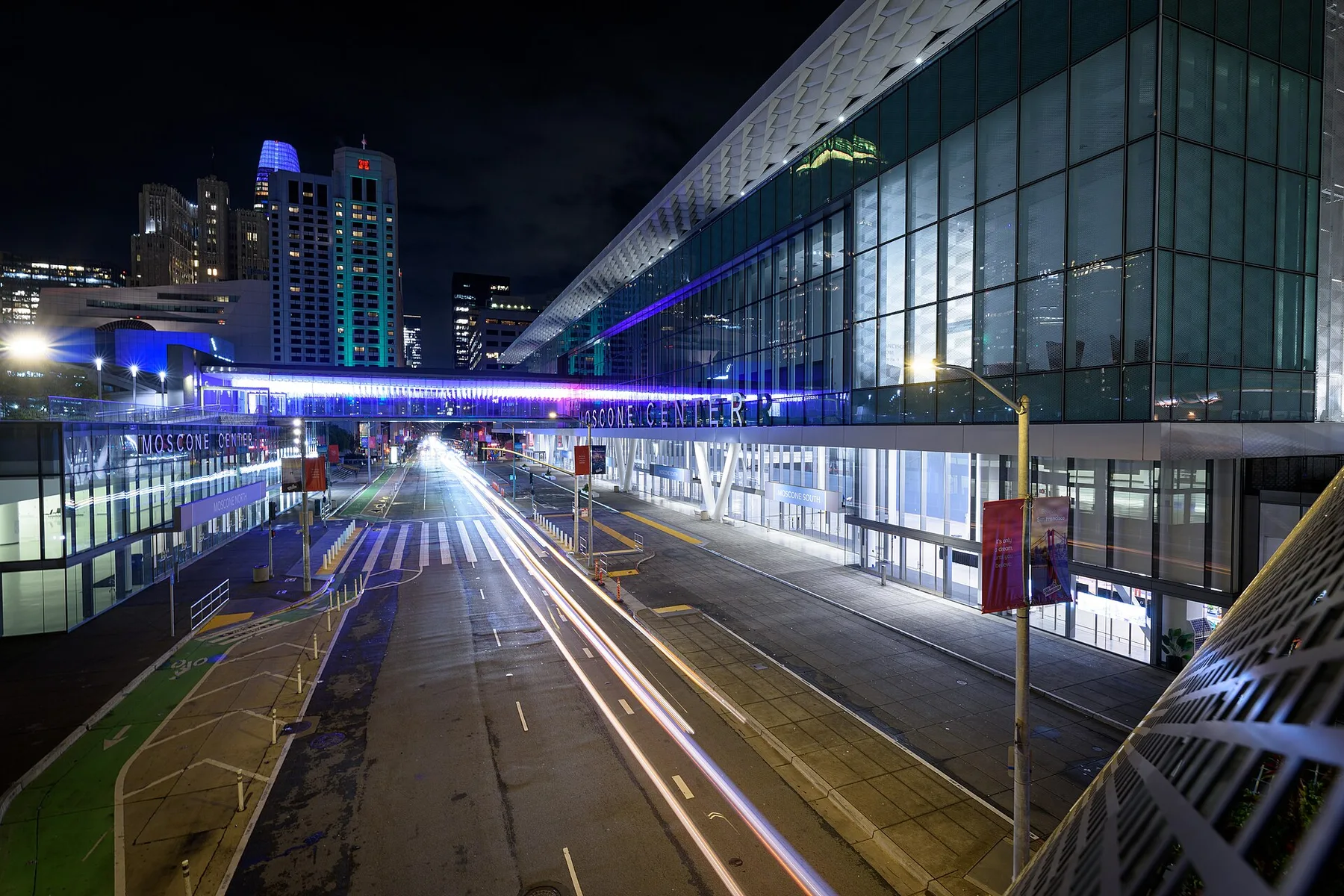 Moscone Center in San Francisco lit up at night, with light trails from traffic on the street outside