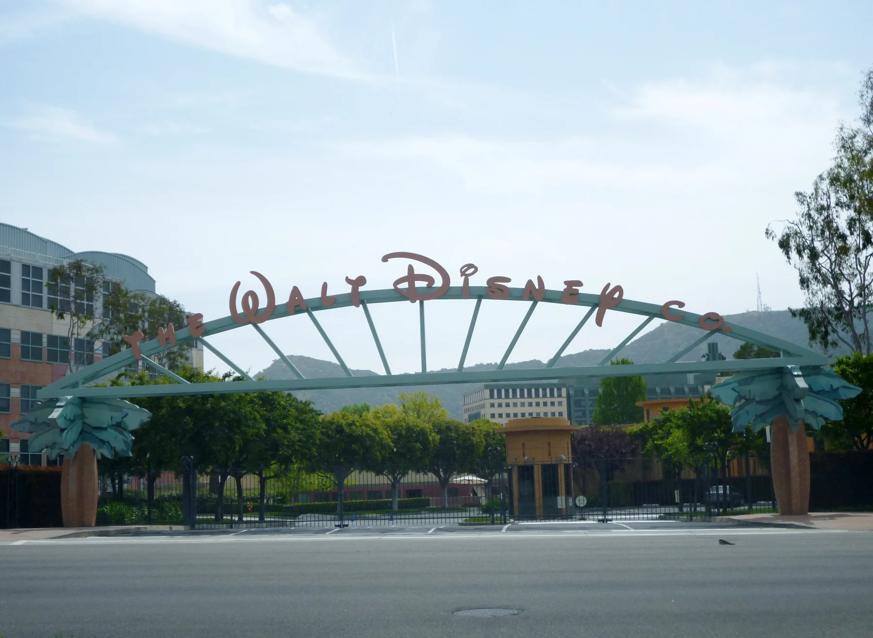 Arched The Walt Disney Co. sign over the gated entrance to Disney studios in Burbank