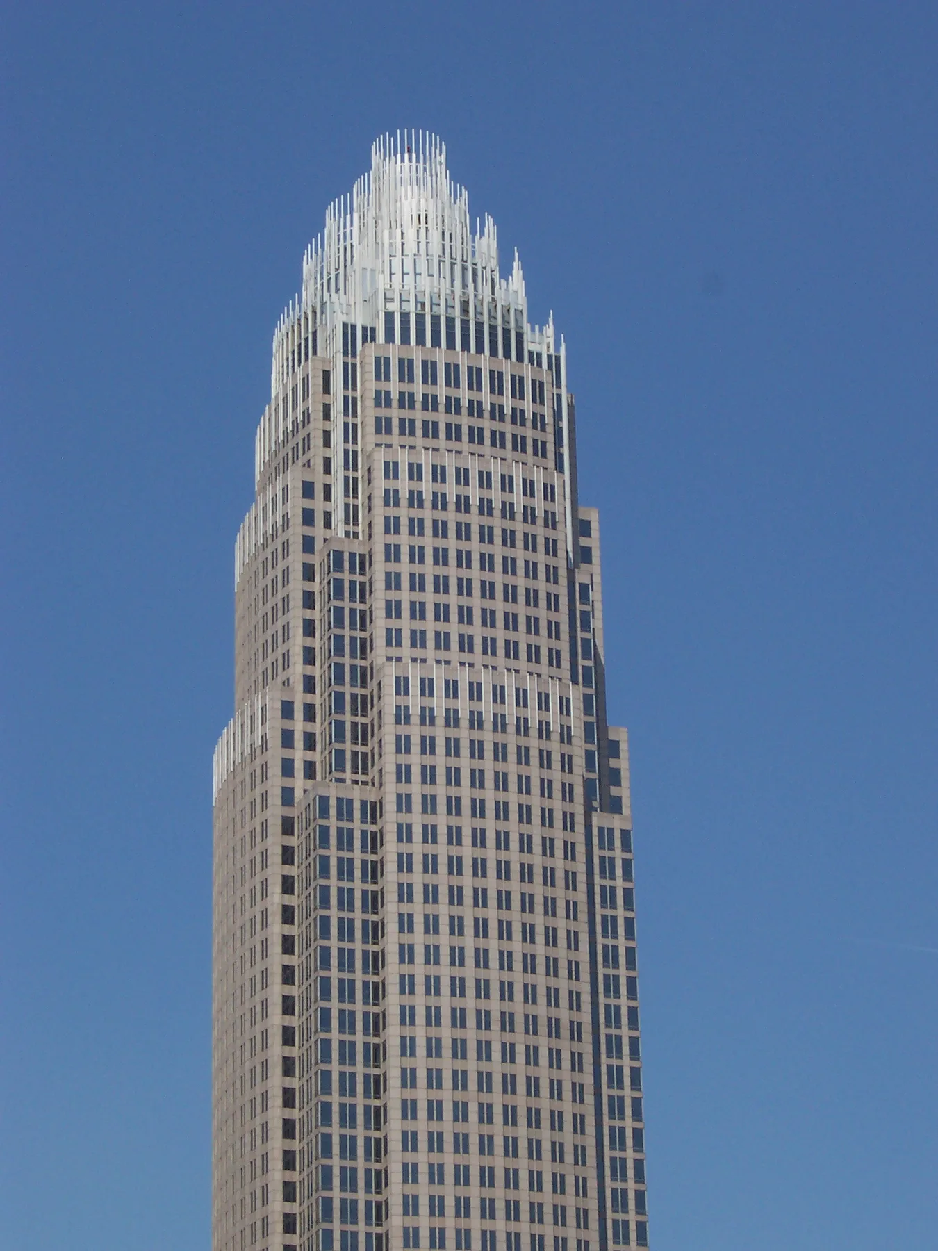 Bank of America Corporate Center tower in Charlotte with its crown of silver spires against a clear blue sky