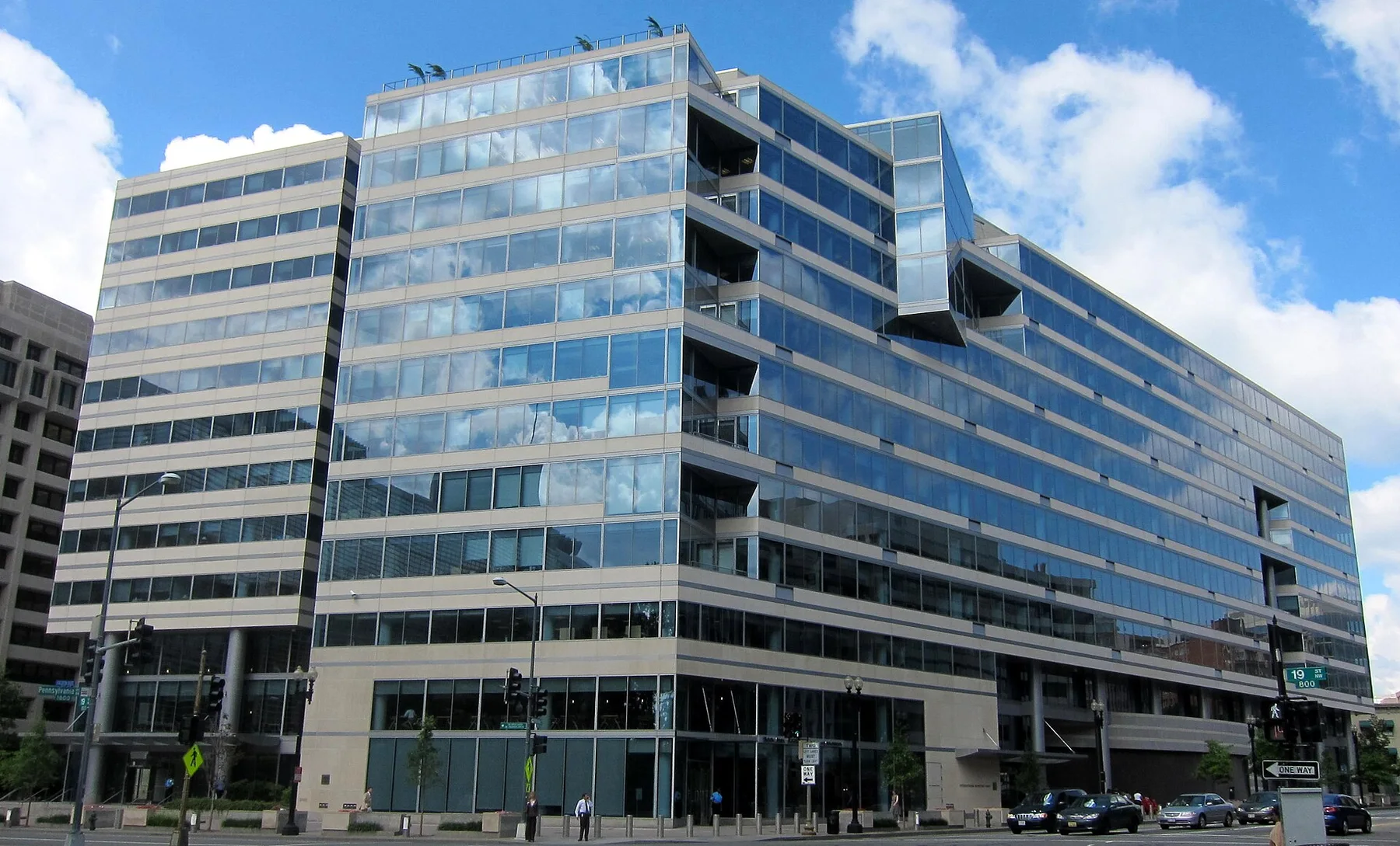 Glass and stone IMF headquarters office block on a Washington street corner under a blue sky