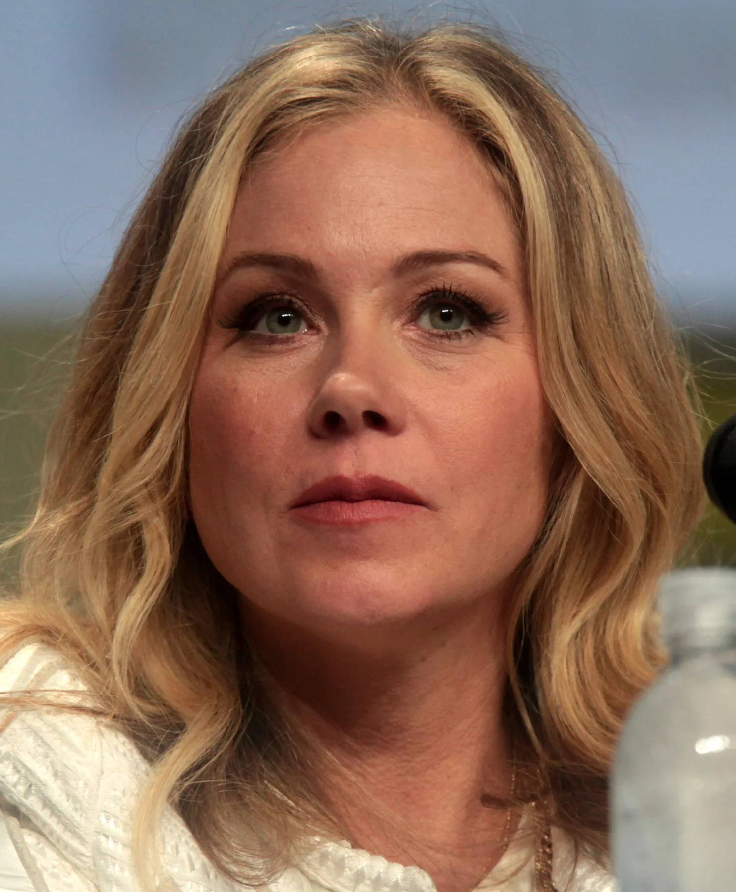 Christina Applegate with long blonde hair, seated at a panel microphone at San Diego Comic-Con