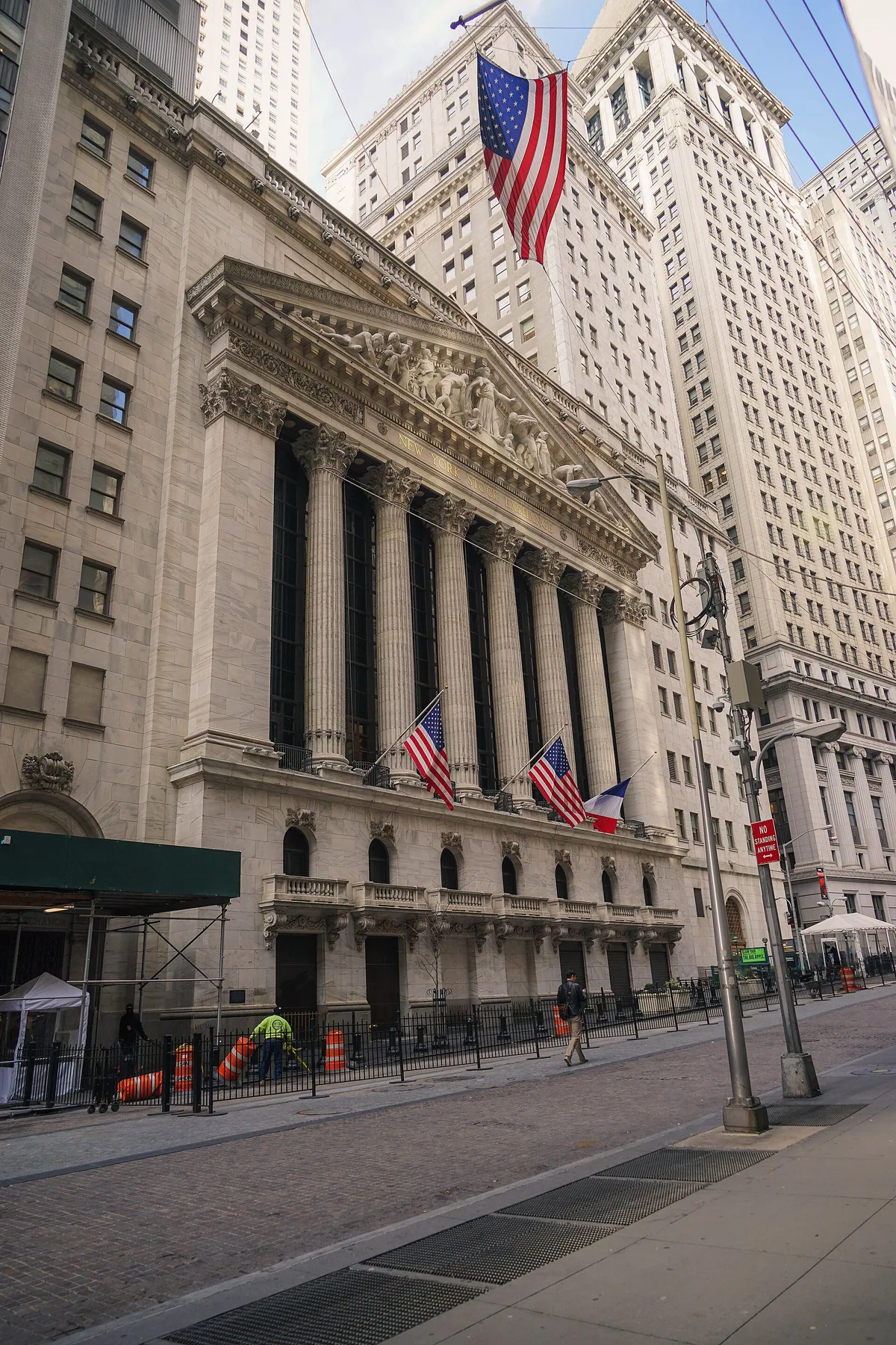 The New York Stock Exchange on Wall Street, its columned facade hung with US flags