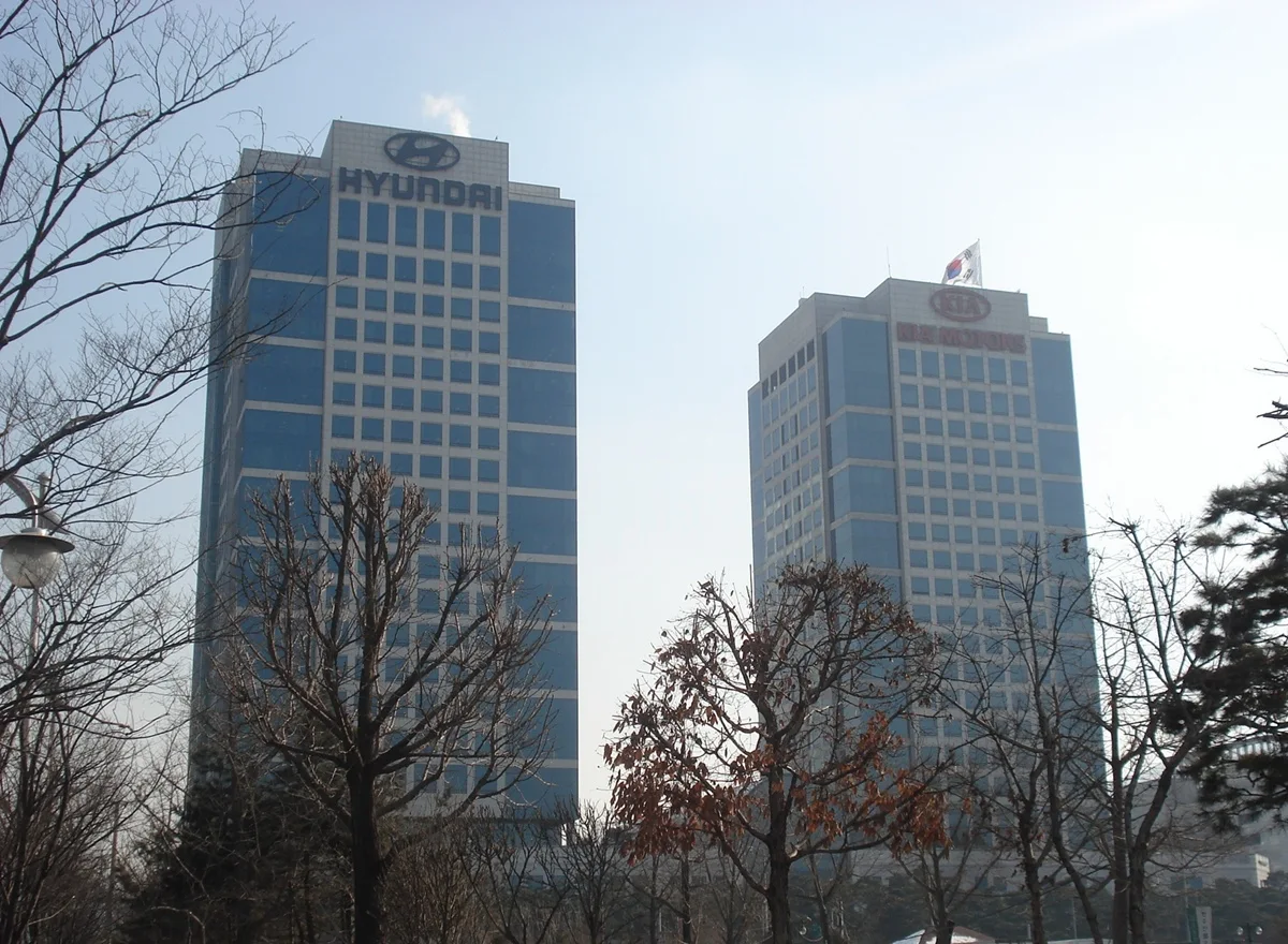 Hyundai and Kia twin office towers in Seoul with bare winter trees in the foreground