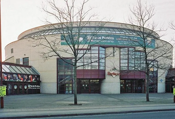 The round York Barbican building with a snooker championship banner above its glass entrance