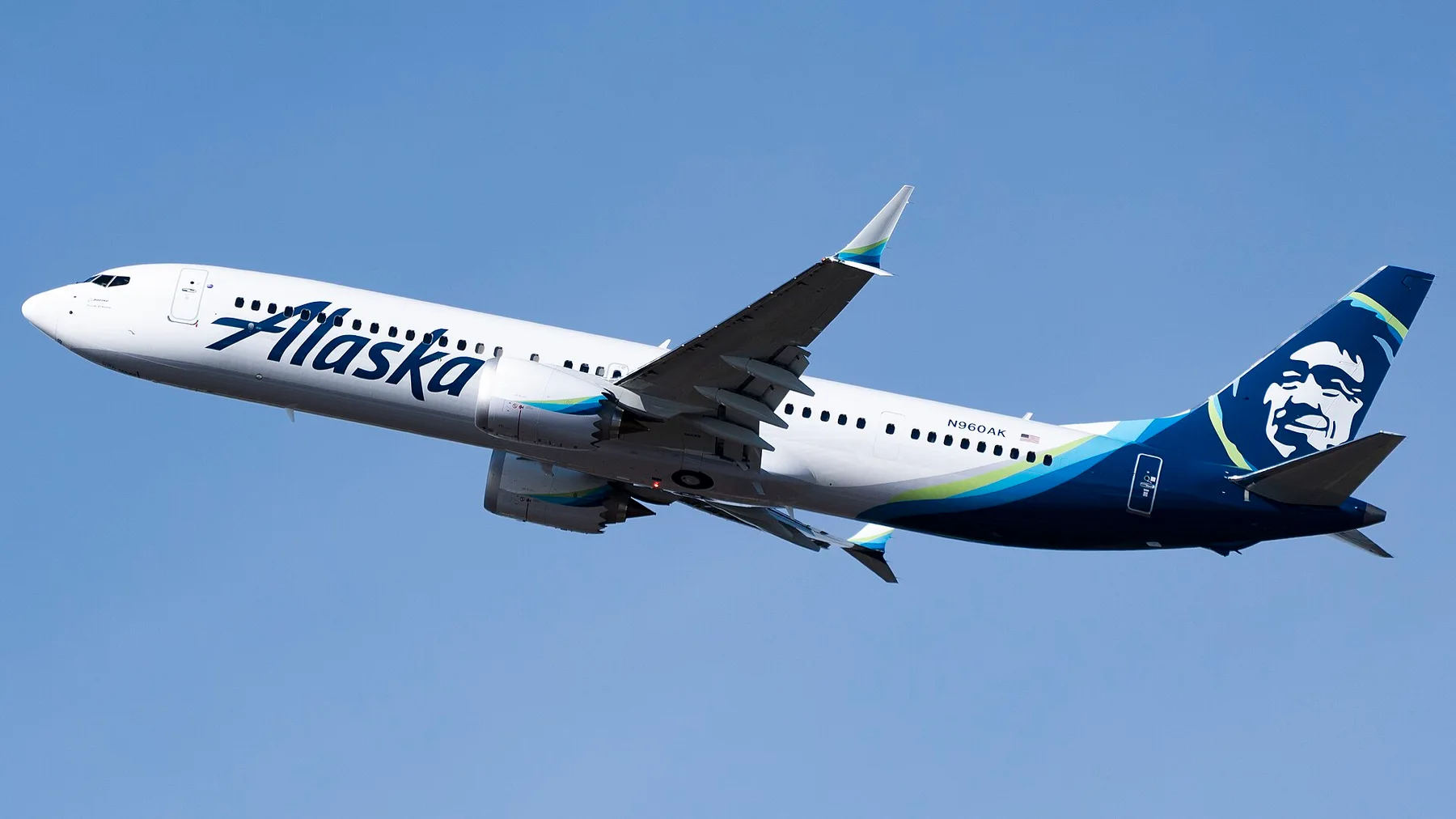 An Alaska Airlines Boeing 737 MAX climbing after take-off against a clear blue sky