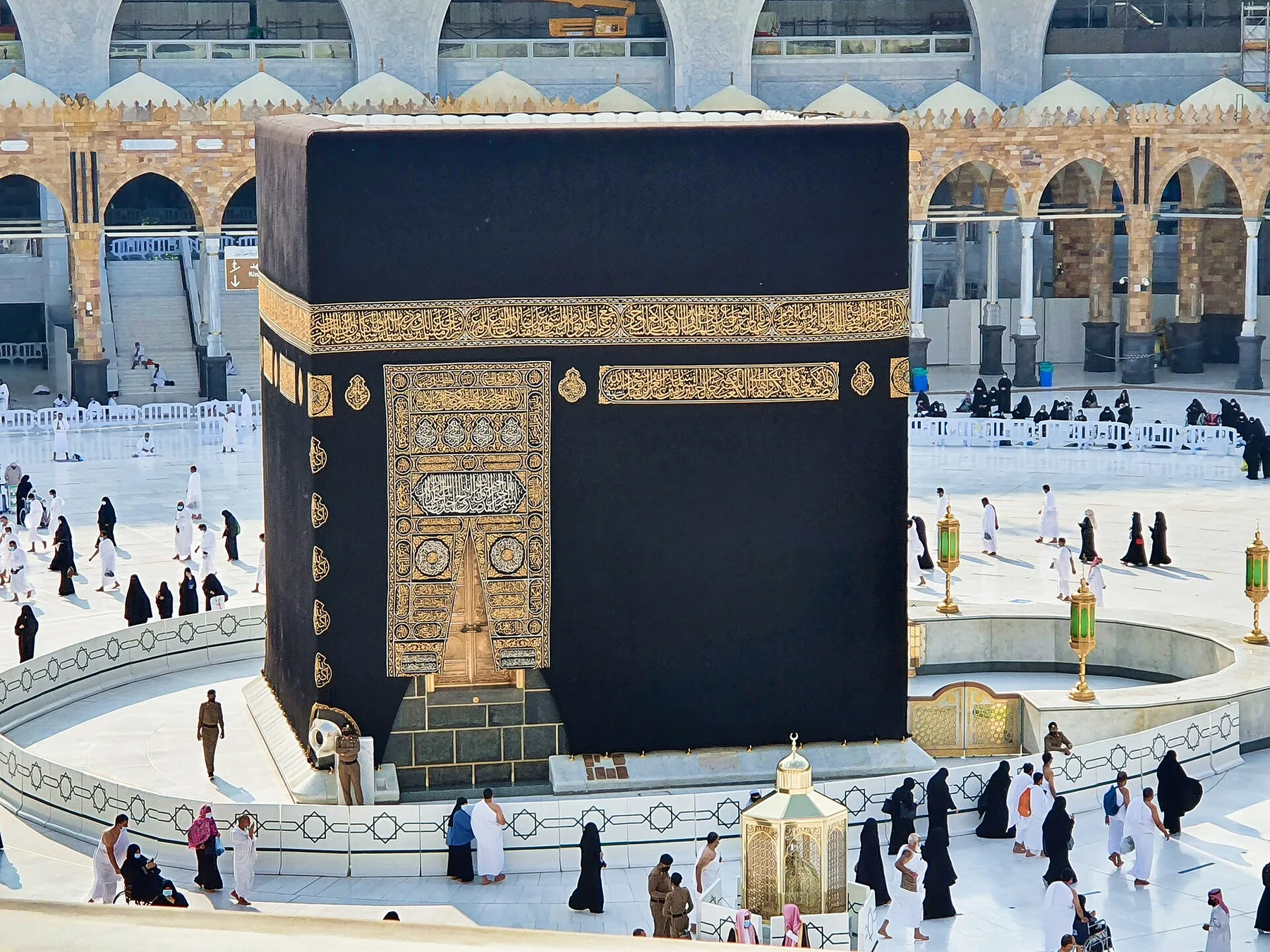 The Kaaba in Masjid al-Haram, Makkah, with pilgrims in white ihram walking around the Mataf