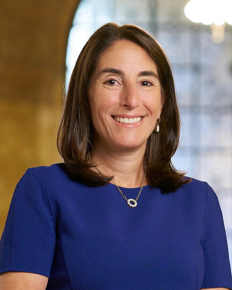 Cleveland Fed President Beth Hammack smiling in a blue dress in an official portrait