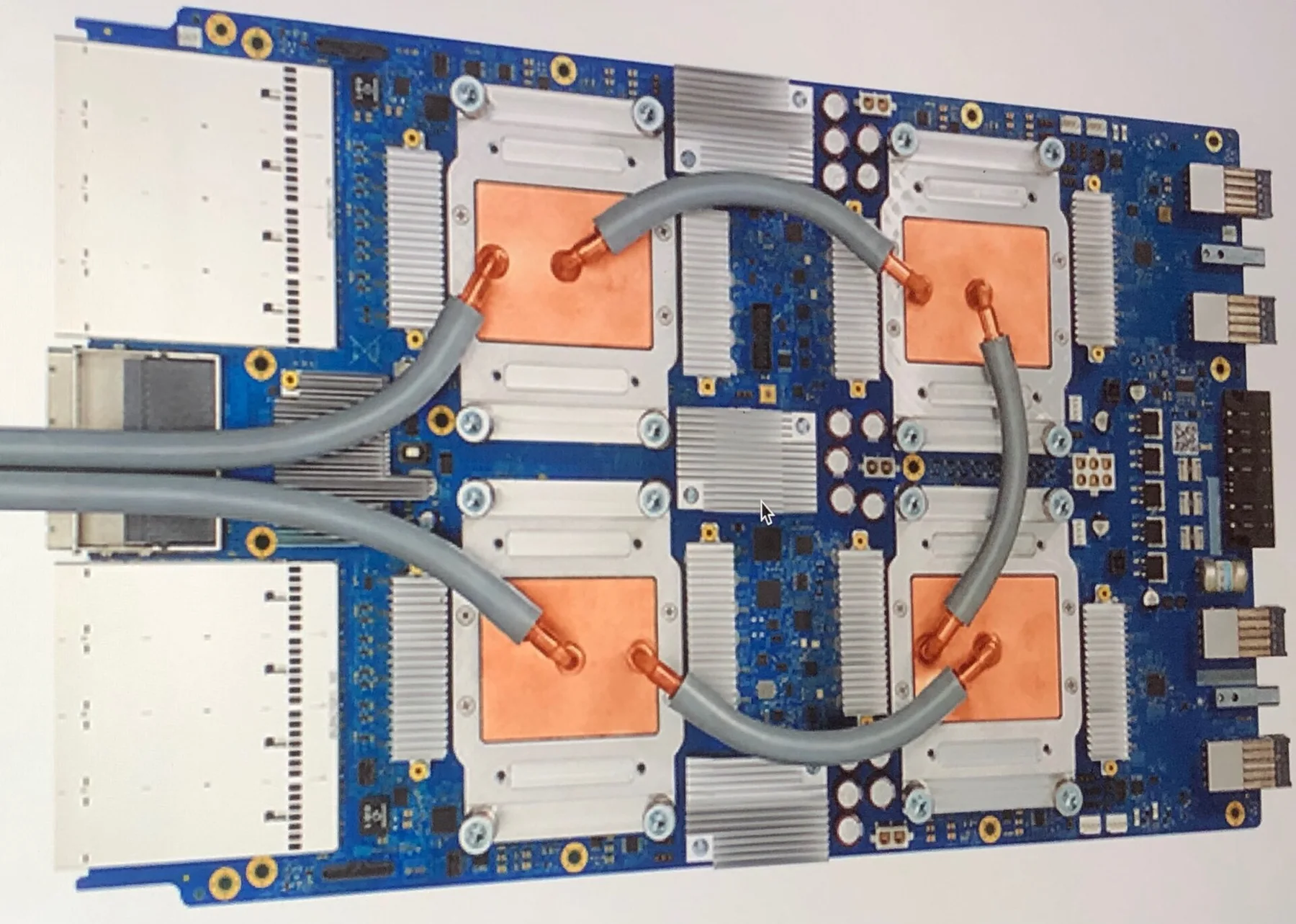 Google TPU circuit board with four copper-plated chips joined by liquid cooling tubes