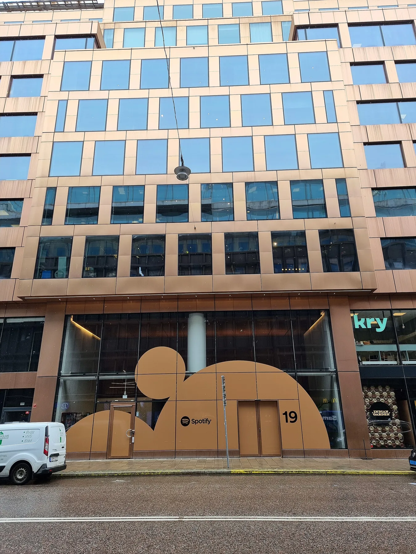 Spotify headquarters in Stockholm, copper facade with the Spotify logo on the ground-floor windows