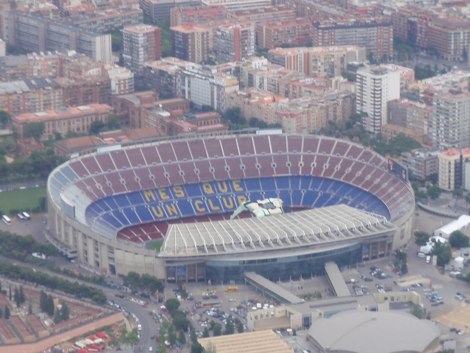 Aerial view of Barcelona's Camp Nou stadium with "Mes que un club" spelled in its blue and red seats