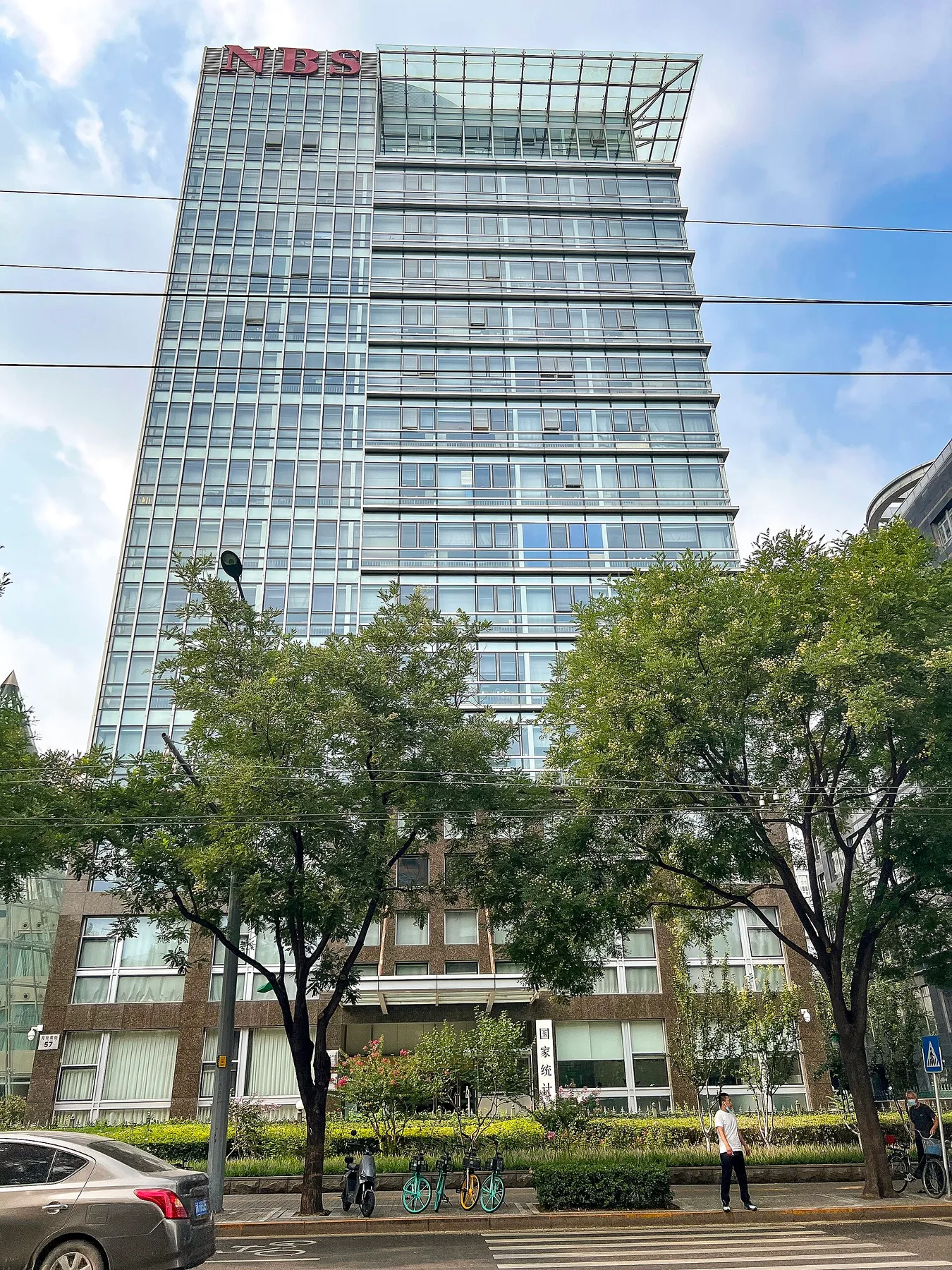 Glass tower of the National Bureau of Statistics of China in Beijing with NBS sign on top
