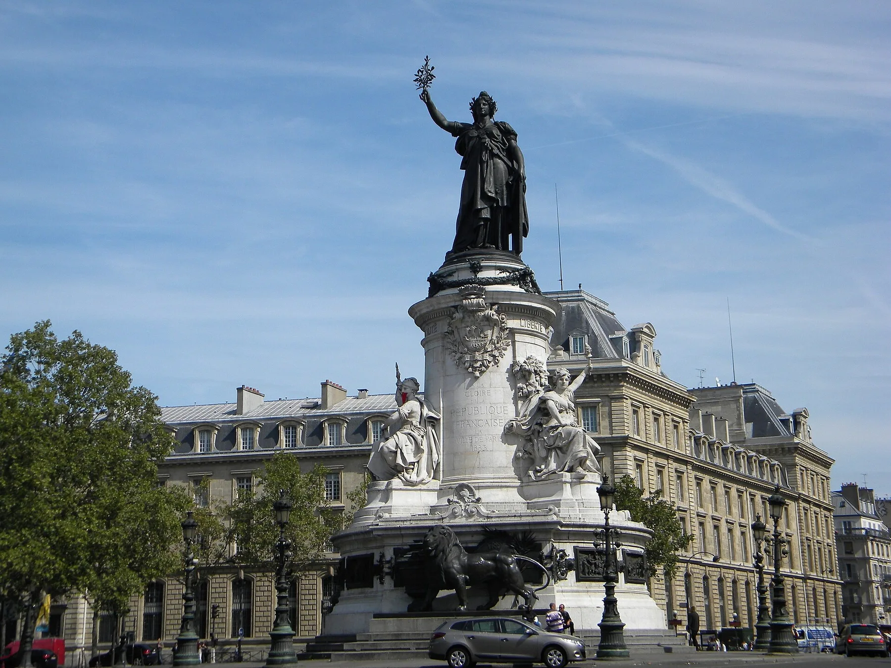 Statue of Marianne on its monument at Place de la Republique in Paris under a blue sky