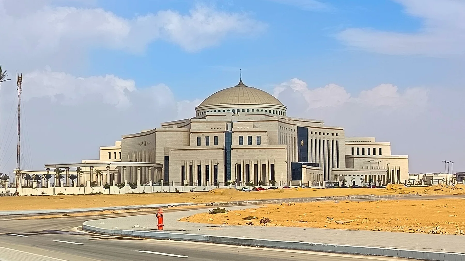Domed Egyptian parliament building in the New Administrative Capital, seen from an empty road