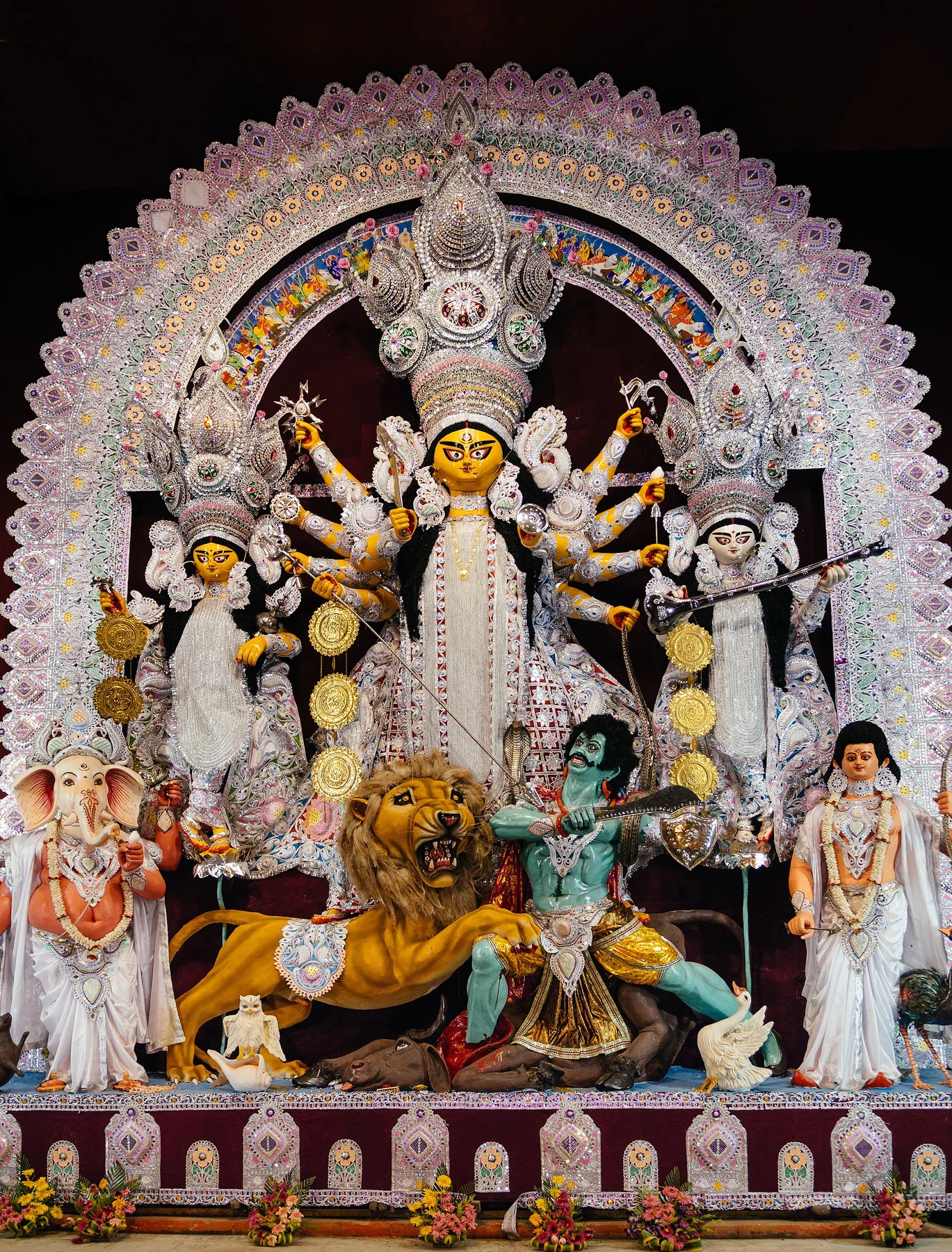 Durga idol with Ganesh, Lakshmi and a lion inside a decorated Durga Puja pandal