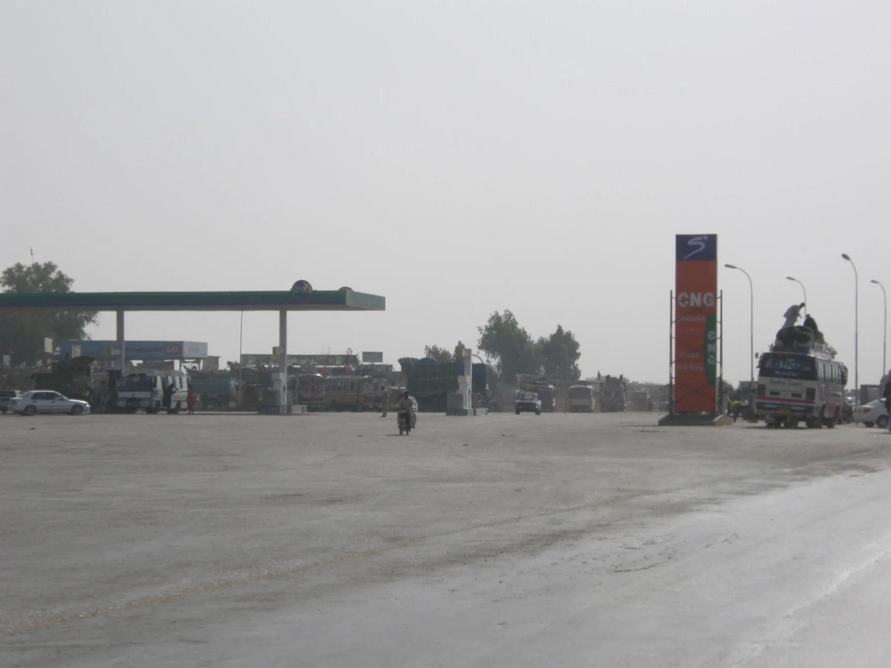 PSO petrol and CNG station with a green canopy and red CNG sign beside a highway in Hyderabad
