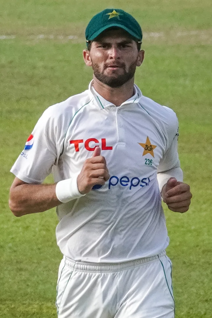 Shaheen Afridi jogging on the field in Pakistan Test whites and a green cap with the star badge