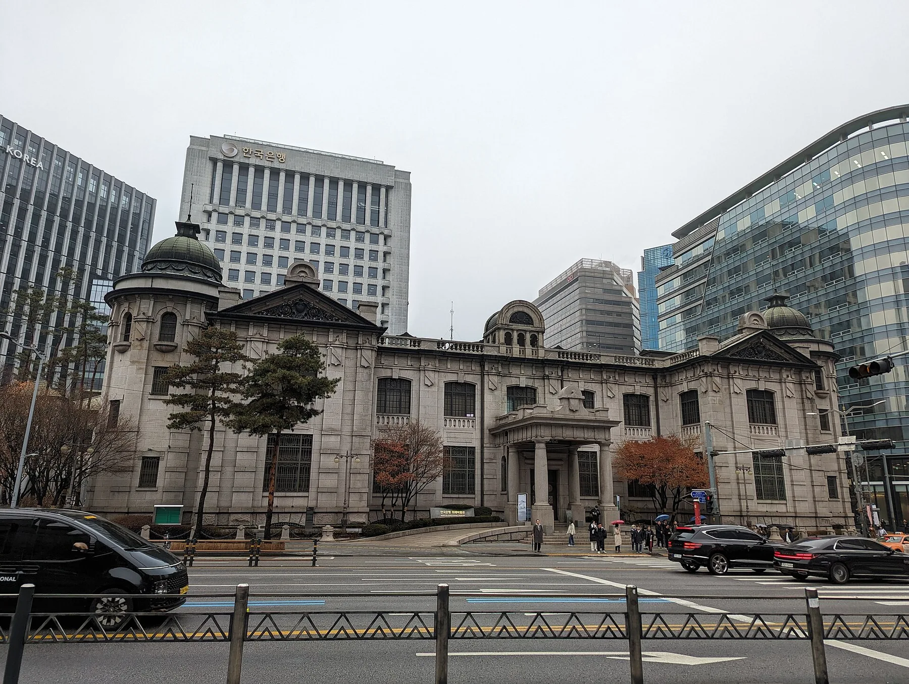 Bank of Korea stone headquarters building with a domed roof and its office tower behind, Seoul street in front