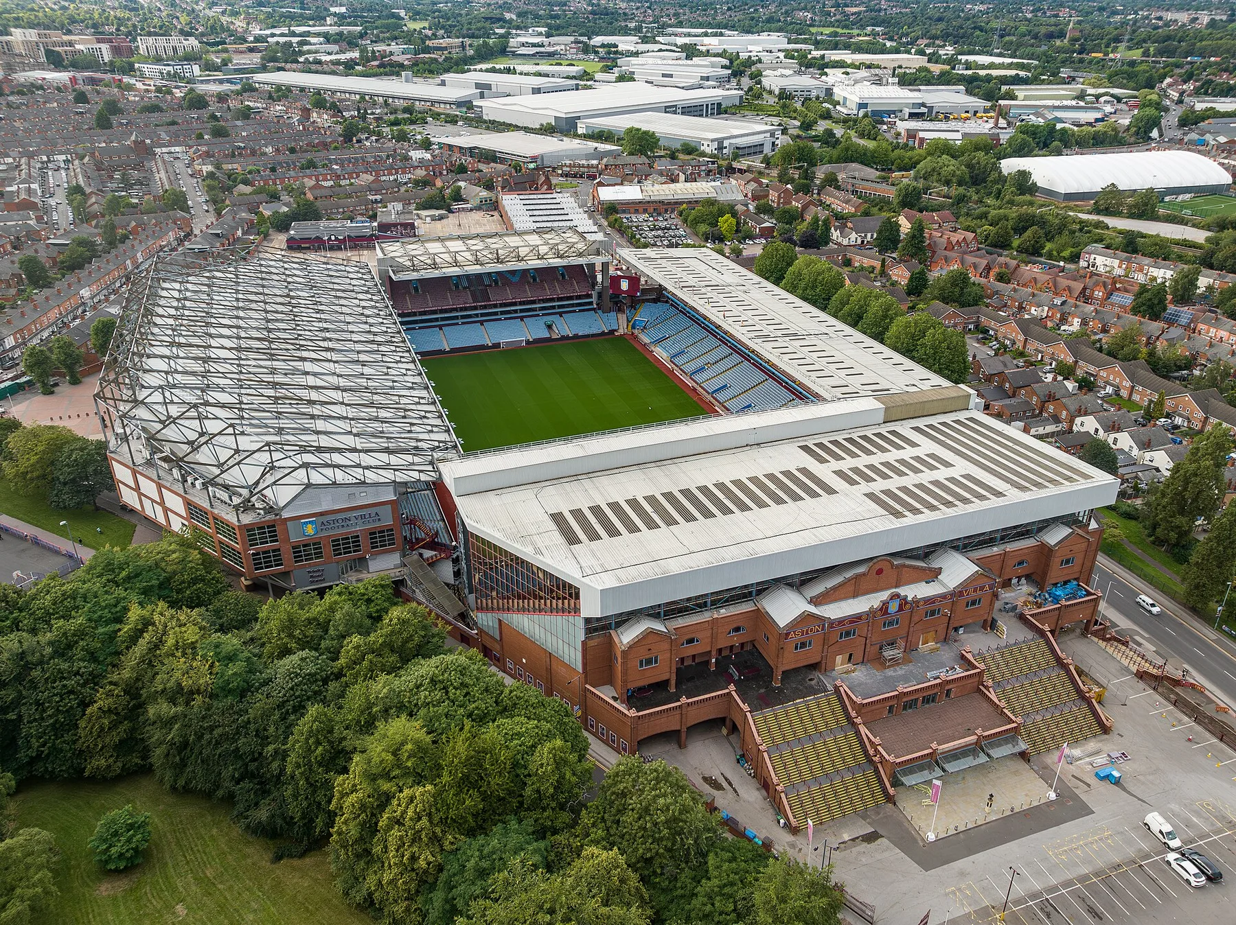 Aerial view of Villa Park stadium in Birmingham, surrounded by red-brick houses and trees