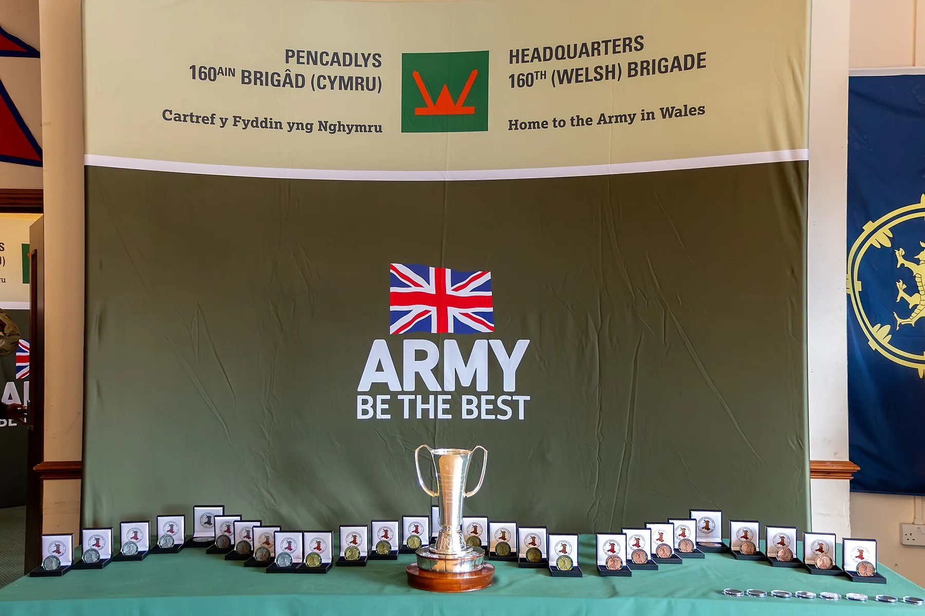 Cambrian Patrol medals and a silver trophy on a table at 160th (Welsh) Brigade headquarters