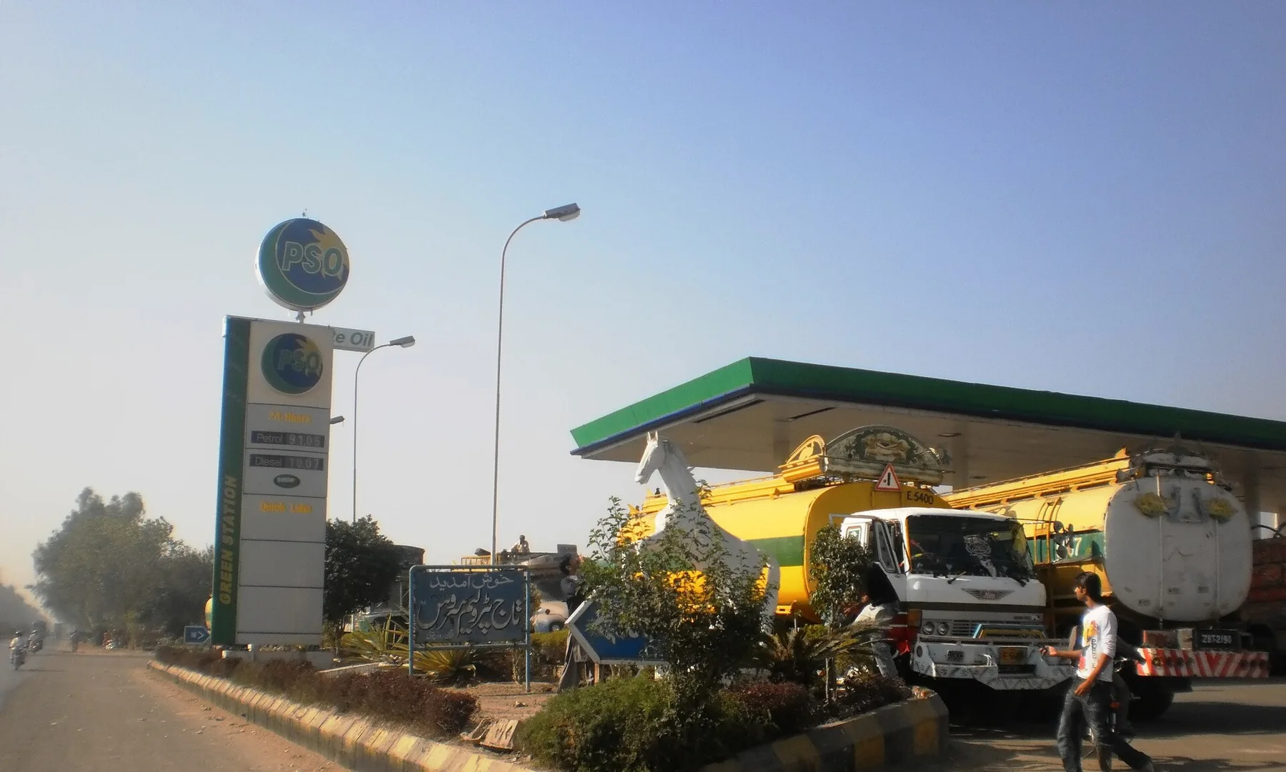 PSO petrol station by a main road with fuel tankers parked under the canopy