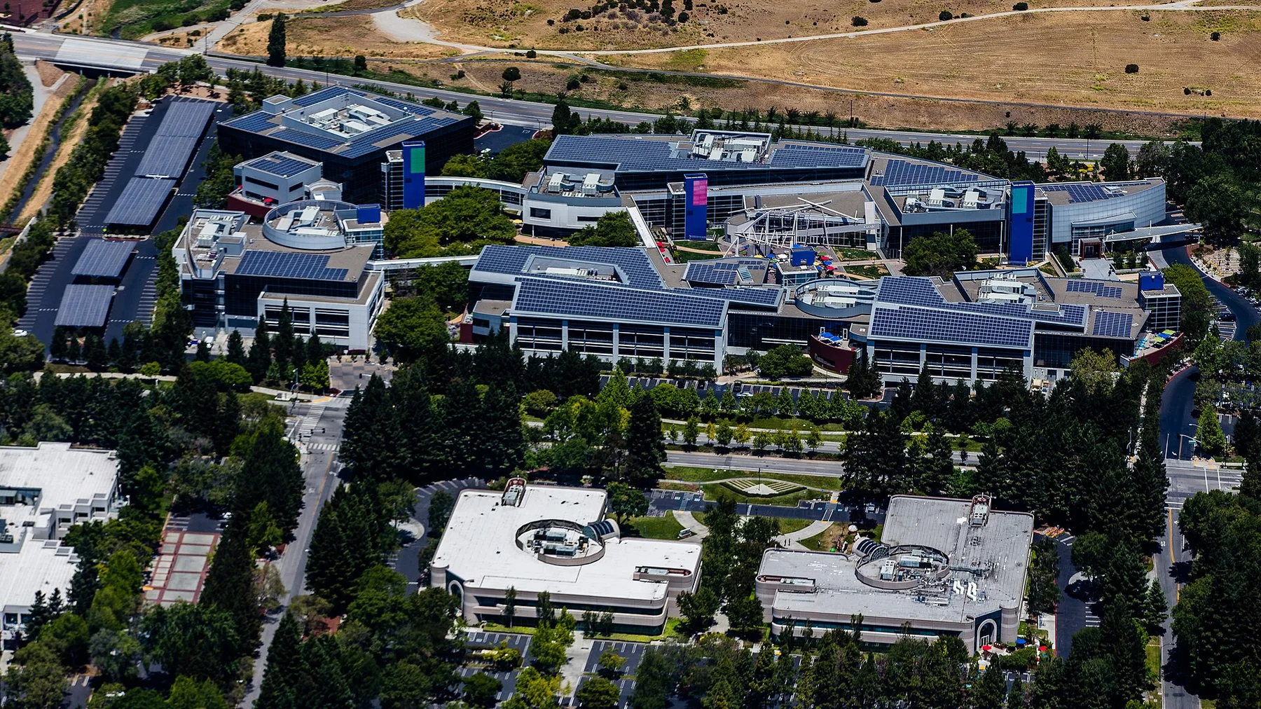 Aerial view of Google headquarters buildings in Mountain View with solar panels on the roofs