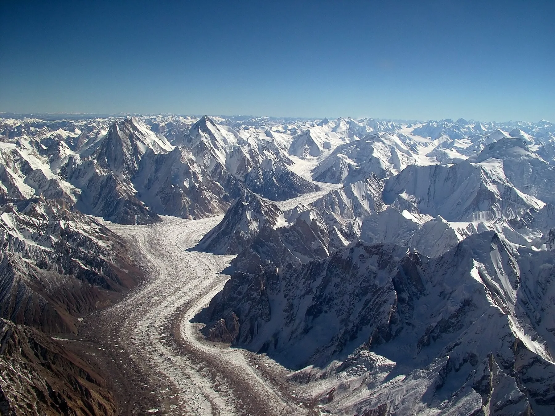 Aerial view of the Baltoro Glacier winding between jagged snow-covered Karakoram peaks