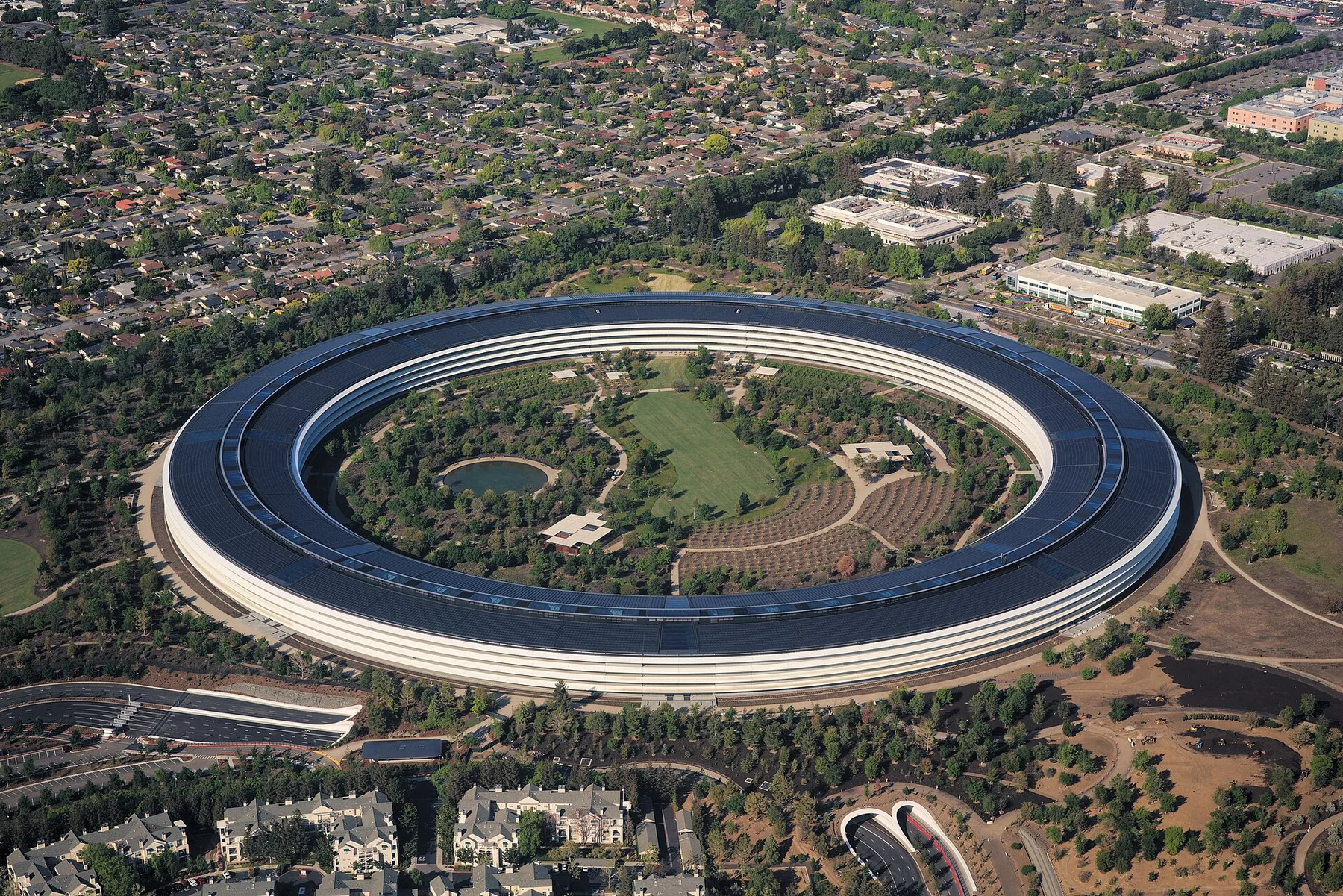 Aerial view of the ring-shaped Apple Park headquarters in Cupertino among trees
