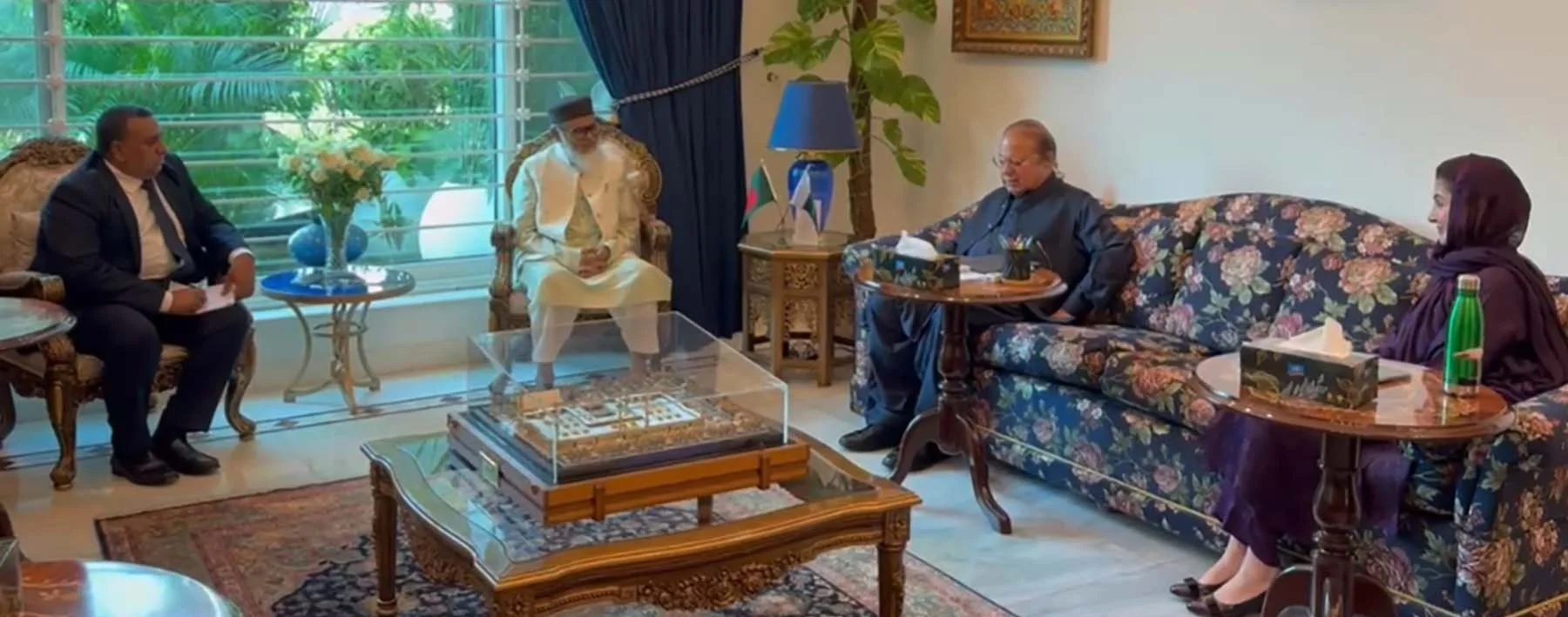 Punjab Chief Minister Maryam Nawaz seated on a floral sofa at a meeting with guests in a drawing room
