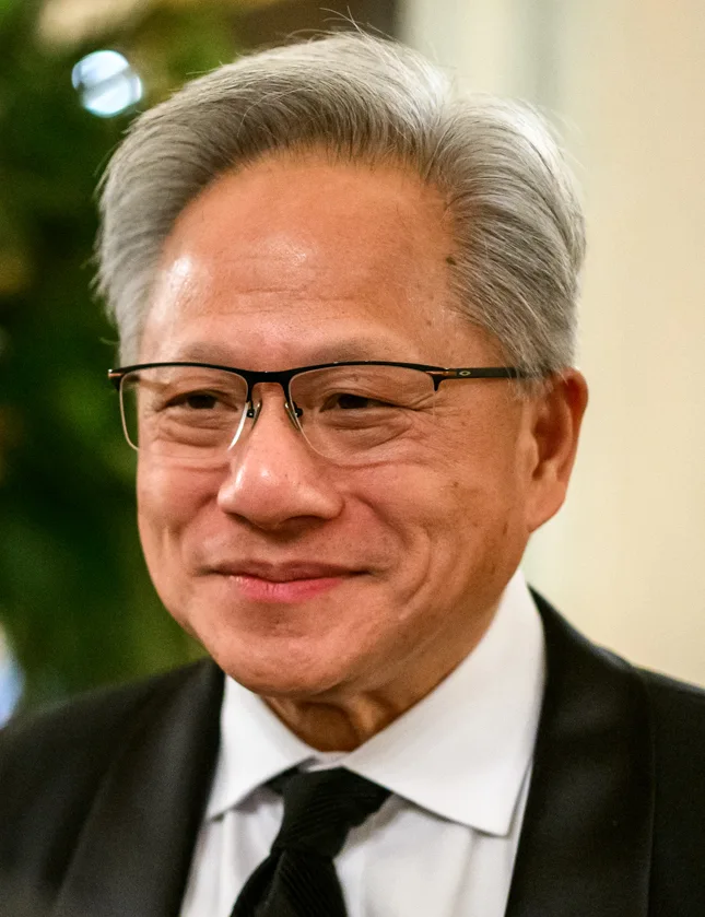 Nvidia chief executive Jensen Huang smiling, wearing glasses, a dark suit and black tie